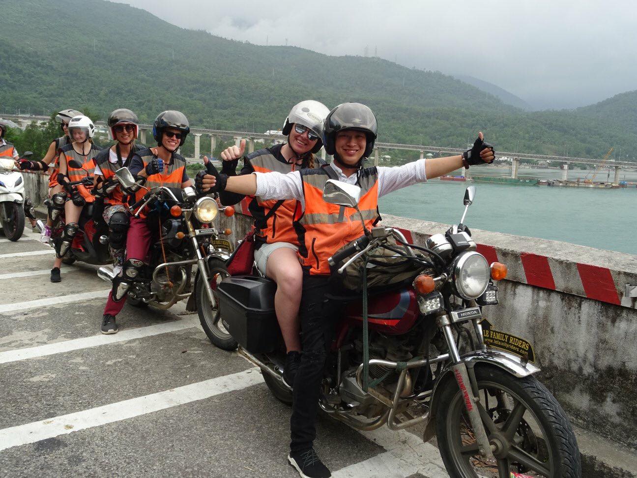Tour guides carry their passengers on motorbikes through Lang Co Bay in Hue. Photo courtesy of Lefamily Riders