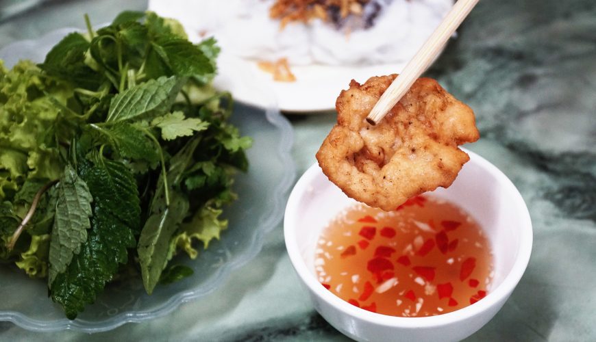 A squid cake is served with steamed rice rolls and chili fish sauce in Ha Long. Photo by VnExpress